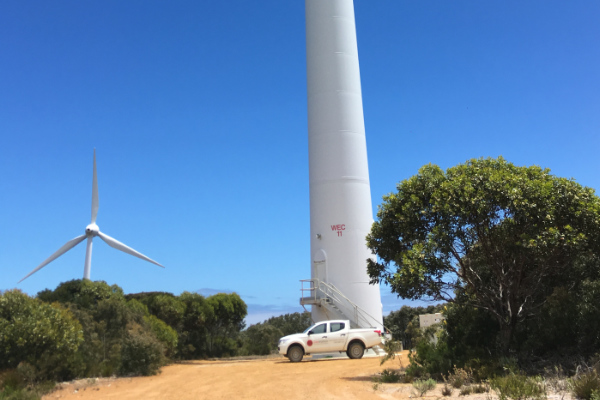 Geomotion Ute next to a big wind turbine